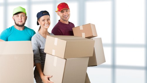 Removal team handling furniture during a Hornsey flat move